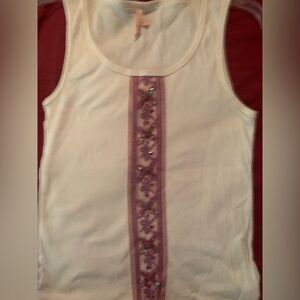 Sleeveless white tank top with beaded ribbon in front.